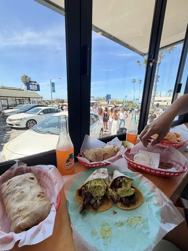 Tacos and a burrito on paper plates at The Taco Stand.
